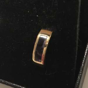Lost: Gold curved stud earring with purple stone lost in High st/ Barrow Street Sat evening 27 April.
